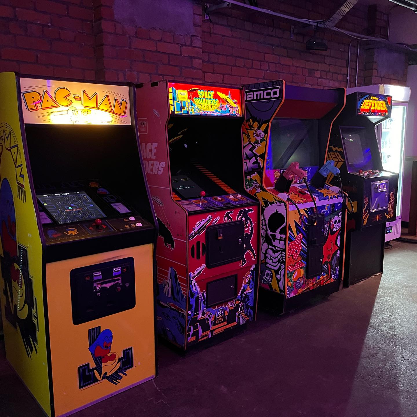 A line-up of classic upright arcade cabinets.